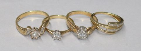 Four assorted 9ct gold and diamond set dress rings, gross 7.7 grams.