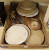 A wooden bread tray, wooden bread boards, carved butter dishes, butter knife, two bread knives and a