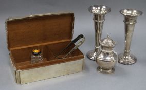 A silver cigarette box, a pair of Mappin and Webb plated posy vases, a plated pepper pot, a pair