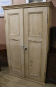 A stripped pine two door wardrobe W.112cm