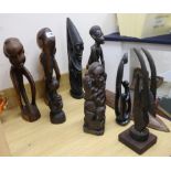 Seven Makonde African tribal carvings, a stone carving and a Papua New Guinea mask tallest 69cm