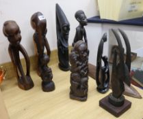 Seven Makonde African tribal carvings, a stone carving and a Papua New Guinea mask tallest 69cm