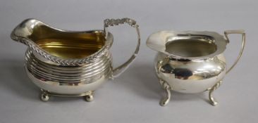 An early 19th century silver cream jug, marks rubbed, circa 1830 and a 20th century silver cream