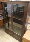 An oak glazed cabinet W.97cm