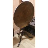 A circular tilt top oak tripod table W.50cm