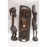 Two Makonde figures and a Papua New Guinea tribal mask and two Makonde figures tallest 95cm