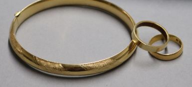 A 22ct gold wedding band, another band with rubbed marks and a Costa Rican hollow gold bracelet