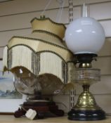 A cut glass lamp and one paraffin lamp