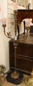 A late 19th century brass Ecclesiastical 3 light candelabrum, fitted with later pink glass shades