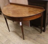 A George III mahogany demi lune side table W.122cm