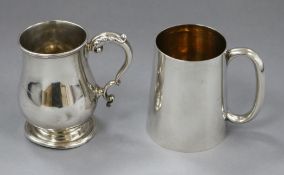An Edwardian plain silver half pint mug, London 1907 and a George V baluster mug, Birmingham 1912
