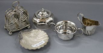A George V silver scallop butter dish with glass liner, a serpentine oval tea caddy, a small cream