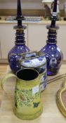 A pair of Egyptian dark blue glass decanters and stoppers, a Chinese blue and white metal mounted