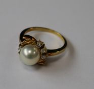 An 18ct pearl and diamond ring