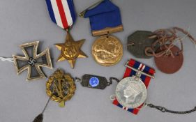 A World War II Group of three medals un-named, a Third Reich iron cross and other items