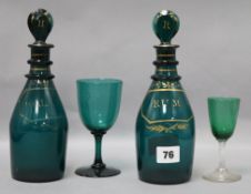 A pair of George III green and gilt glass Rum and Holland decanters and two glasses decanters height