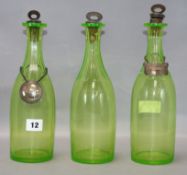 A set of three Victorian uranium glass decanters, with plated labels, the Gin label is silver