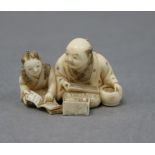 A Japanese ivory netsuke of a teacher and pupil