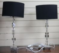 A pair of Porta Romana tall glass lamps with black shades overall height 66cm