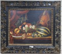 18th century style Dutch School, oil on canvas, still life with pomegranates, a melon and a violin