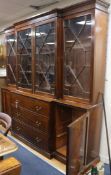 A Georgian style mahogany breakfront glazed bookcase with three drawers and cupboard to base W.232cm