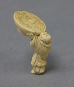 A Japanese ivory netsuke of a man drinking from large bowl
