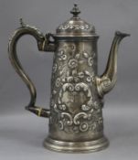 A mid 18th century English silver coffee pot, with later embossed decoration, marks rubbed gross