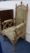 A Victorian Gothic revival oak armchair, with tapestry upholstered back, arms and seat, and carved