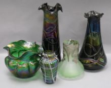 A Loetz style lobed iridescent green wavy rim vase and four other glass vases, including a small