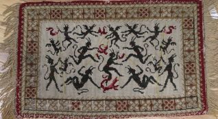 A Victorian needlepoint woven with demons 54 x 87cm