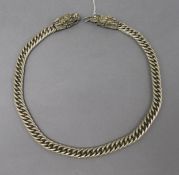 A Chinese white metal necklace with dragon head clasps