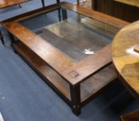 A glass topped hardwood coffee table W.160cm H.50cm