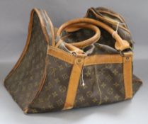 A small Louis Vuitton bag with tan leather handles and edges (worn)