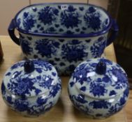 A Staffordshire style blue and white pottery footbath and a pair of lidded bowls Largest length 47cm