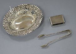 An Edwardian pierced silver trinket dish, 13cm, a pair of sugar tongs and a matchbox holder