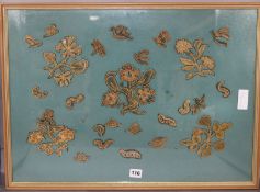 A framed collection of early needlework motifs of flowers, snails and butterflies 44 x 50cm