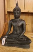 A small brown patinated seated figure of Buddha