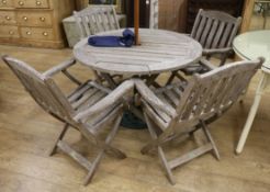 A Swan Attersley teak garden table with four folding chairs and parasol
