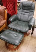 A green leather upholstered reclining armchair and matching stool