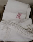 A collection of eight French provincial linen sheets, some with red embroidered monograms