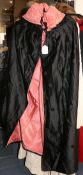 A Victorian black silk cape with pink lining