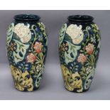 A pair of Moorcroft 'Golden Lily' baluster vases, dark blue ground, designed by Rachel Bishop,