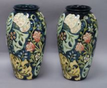 A pair of Moorcroft 'Golden Lily' baluster vases, dark blue ground, designed by Rachel Bishop,