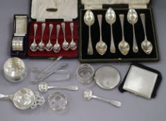 Two cased sets of six silver spoons and other small silver items including napkin rings, strainer