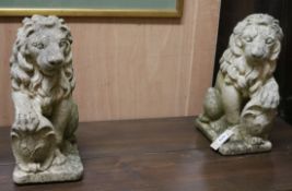 A pair of reconstituted stone lions W.15cm