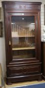 A 19th century French "plum pudding" mahogany bookcase, enclosed by a single glazed door W.115cm