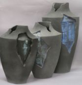 Three contemporary grey stoneware vases by Amanda King, slab-built, each of layered shield form with