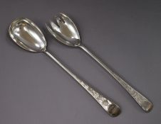 A matched pair of Georgian silver salad servers, different dates and makers,