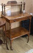 A Victorian walnut three-tier whatnot with fitted writing drawer W.59cm