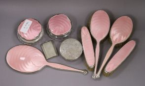 A 1930's matched eight piece silver and enamel dressing table set, a powder jar and silver match